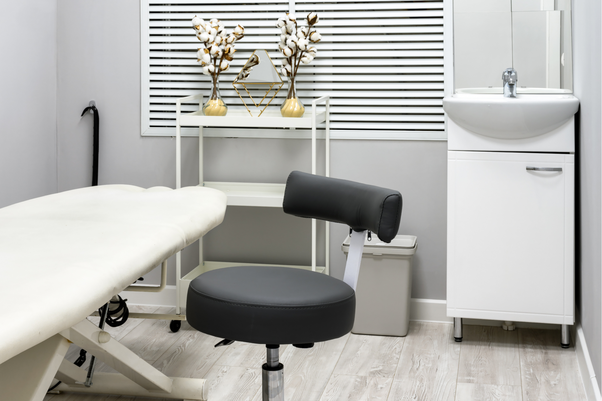 massage room layout example showing spa room design with treatment table, stool, and sink for efficient therapist flow