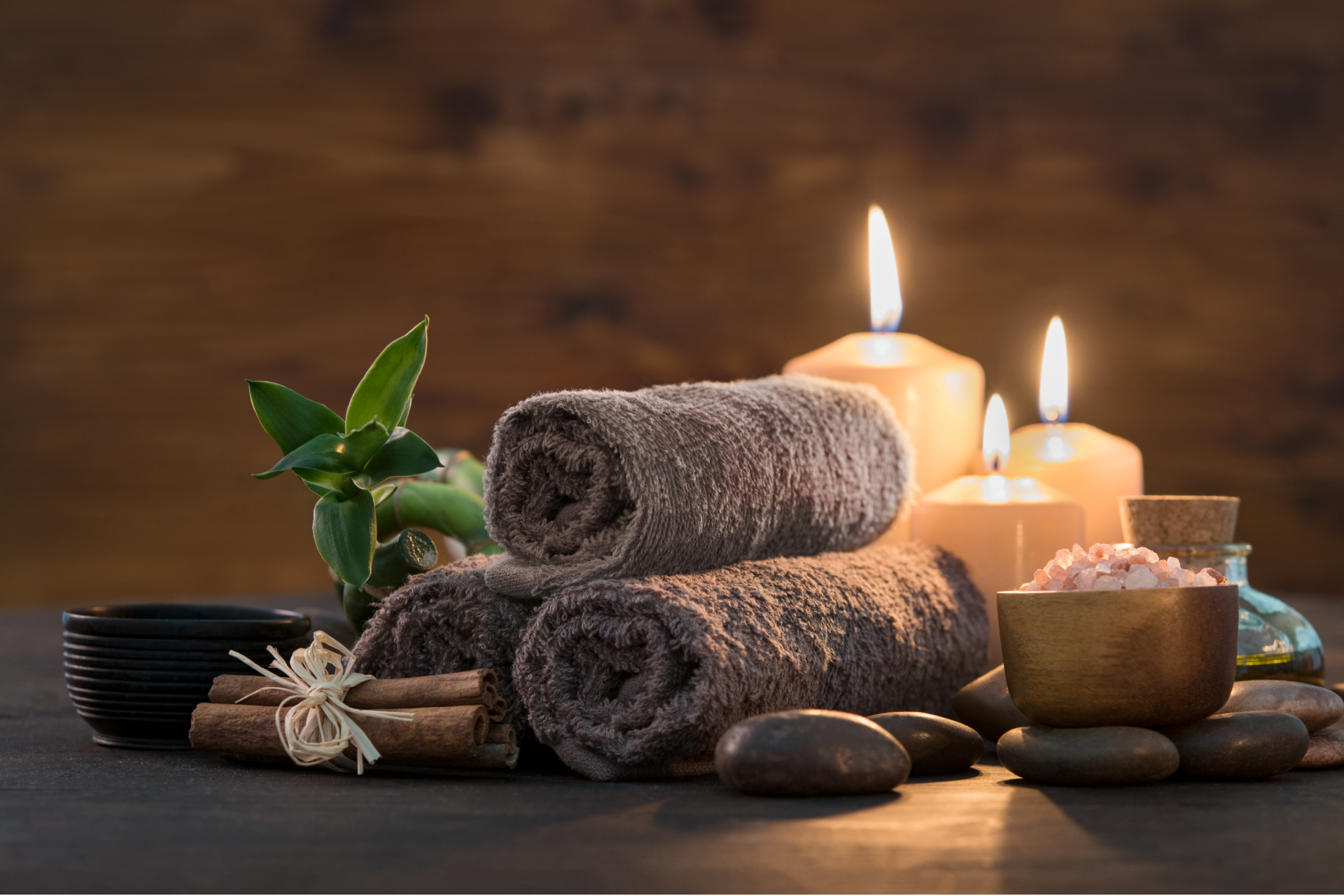 massage room lighting setup with candles and warm tones creating relaxing spa ambiance in a zen massage room