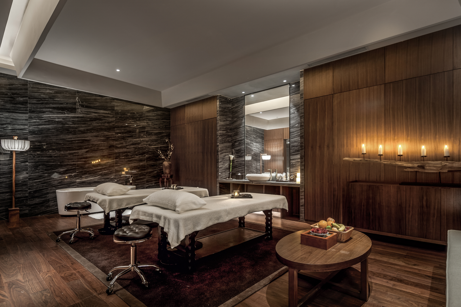 massage room ideas for spa interior design showing a relaxing treatment room with calm, natural decor