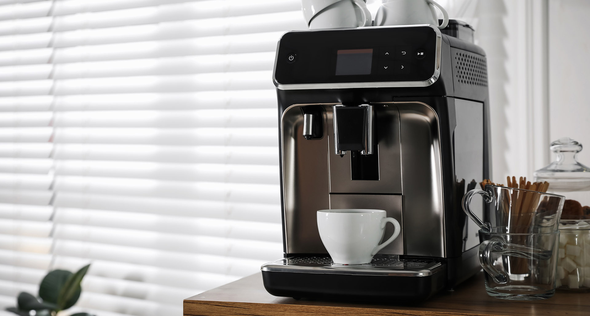 Modern coffee maker with mugs and sweeteners at an Airbnb beverage station