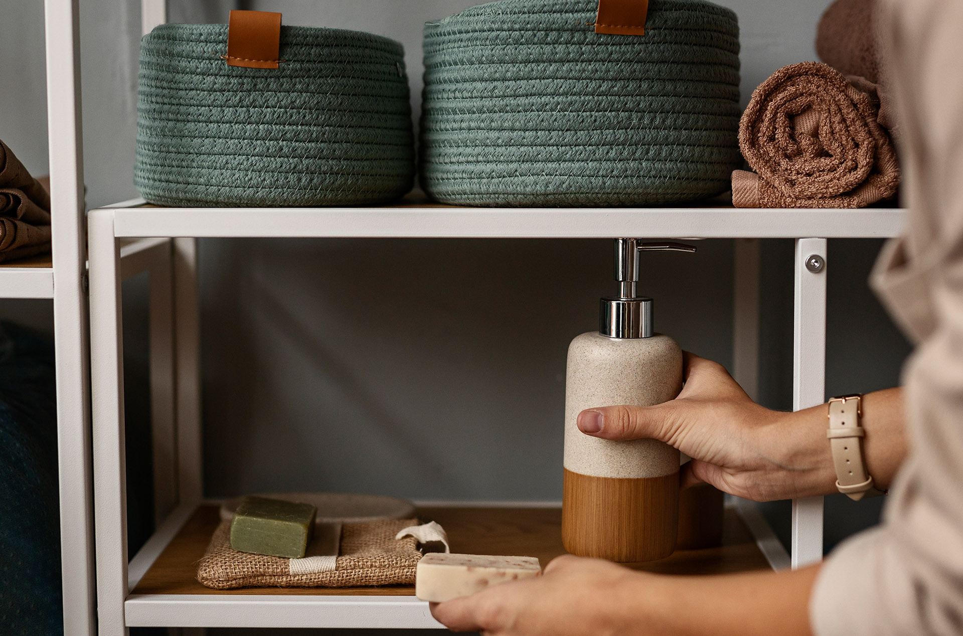 Housekeeper restocking hotel guest room amenities 