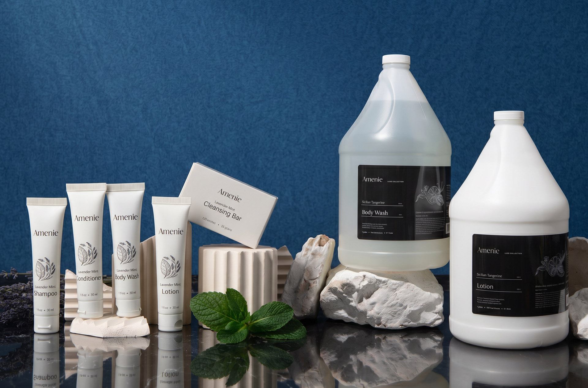 Single-use hotel toiletries next to bulk refill and dispenser
