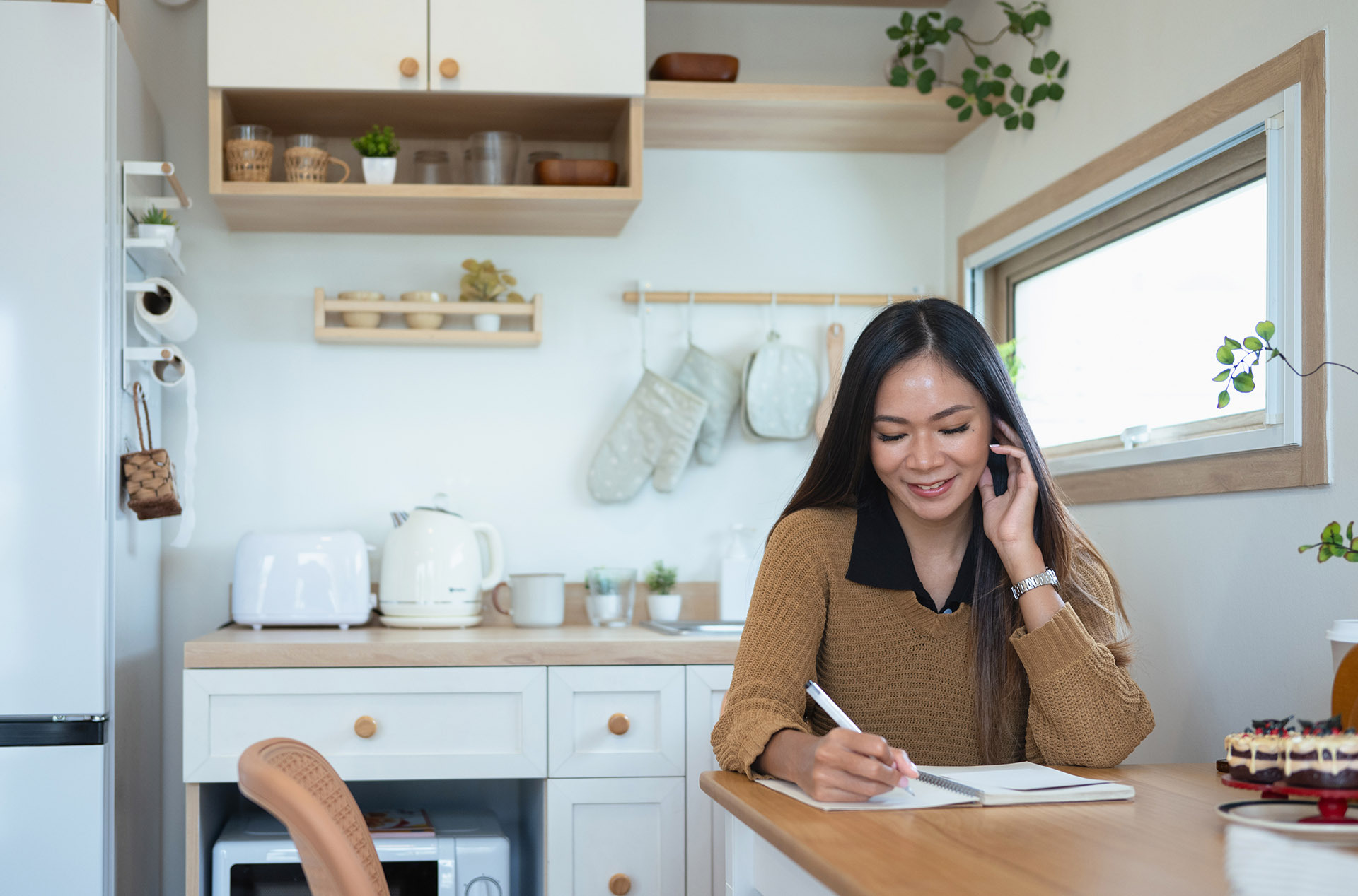 Airbnb host writing a restocking checklist while ordering bathroom supplies from Amenie—bulk toiletries, dispensers, and fast-shipping refills.